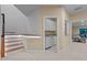Basement with illuminated stairs, doorway to a kitchen/bar, and a window for natural light at 417 Swans Mill Xing, Raleigh, NC 27614