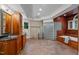 Large primary bathroom with tile floors, glass block shower, and wood cabinets at 417 Swans Mill Xing, Raleigh, NC 27614