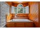 Bathtub with window view of nature and shuttered windows at 417 Swans Mill Xing, Raleigh, NC 27614