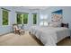 Bedroom with neutral carpet, ample natural light, and an accent chair at 417 Swans Mill Xing, Raleigh, NC 27614