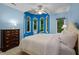 Bright bedroom features an oversized window, soft carpet, and blue painted walls at 417 Swans Mill Xing, Raleigh, NC 27614