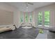 Bonus room boasts natural light, French doors, and cushioned seating at 417 Swans Mill Xing, Raleigh, NC 27614