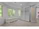 Large bonus room featuring built-in storage cabinets and shelving, plus natural light through the surrounding windows at 417 Swans Mill Xing, Raleigh, NC 27614