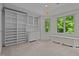 Large bonus room featuring built-in shelves and drawers, mini fridge, and a great view of the surrounding greenery at 417 Swans Mill Xing, Raleigh, NC 27614