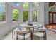 Bright breakfast nook with large windows and a round table, perfect for casual dining at 417 Swans Mill Xing, Raleigh, NC 27614