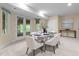 Light-filled dining area with table set for a meal and glass doors leading to the backyard at 417 Swans Mill Xing, Raleigh, NC 27614