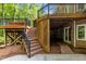 Backyard featuring stairs to a hot tub deck with wooden privacy wall and access to the home's lower level at 417 Swans Mill Xing, Raleigh, NC 27614
