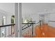 Bright foyer with hardwood floors, elegant staircase, chandelier, and large windows with wooded views at 417 Swans Mill Xing, Raleigh, NC 27614