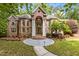 Stunning brick home featuring a grand entrance with stately columns and lush landscaping at 417 Swans Mill Xing, Raleigh, NC 27614