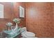Unique half bath features bowl sink and copper colored tile wallpaper at 417 Swans Mill Xing, Raleigh, NC 27614