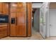 Wood built-in refrigerator and microwave area with cabinets in an open concept kitchen at 417 Swans Mill Xing, Raleigh, NC 27614