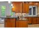 Close-up of an elegant kitchen island featuring dark countertops, wood cabinets and modern fixtures at 417 Swans Mill Xing, Raleigh, NC 27614