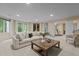 Bright basement living room with large sofa, coffee table, and open flow to other areas at 417 Swans Mill Xing, Raleigh, NC 27614
