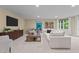 Spacious living room with a large sofa, TV, and view into the dining area with natural light at 417 Swans Mill Xing, Raleigh, NC 27614