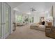 Spacious main bedroom features a tray ceiling, seating area, French doors, and large windows with outdoor views at 417 Swans Mill Xing, Raleigh, NC 27614