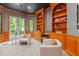 Sitting area in office with custom wood built-ins and French doors to the backyard at 417 Swans Mill Xing, Raleigh, NC 27614