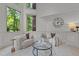 Bright sitting area featuring tall windows, comfortable chairs, and stylish decor elements at 417 Swans Mill Xing, Raleigh, NC 27614