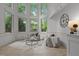 Inviting sitting area with floor-to-ceiling windows, comfortable seating, and elegant decor at 417 Swans Mill Xing, Raleigh, NC 27614