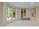 Sitting area with French doors to the backyard, a cushioned bench, and natural light at 417 Swans Mill Xing, Raleigh, NC 27614