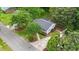 Aerial view of a home with mature trees, a driveway, and landscaping at 423 N Main St, Wendell, NC 27591