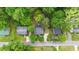 Aerial view of a home with mature trees, a driveway, and landscaping at 423 N Main St, Wendell, NC 27591