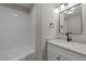 Modern bathroom featuring a tub, granite countertop, and a vanity with a framed mirror at 423 N Main St, Wendell, NC 27591