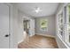 Cozy bedroom with wood-look floors, two windows for natural light, and a fresh, neutral paint scheme at 423 N Main St, Wendell, NC 27591