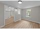 Spacious bonus room has new wood-look flooring with natural light, and convenient access to kitchen and exterior at 423 N Main St, Wendell, NC 27591