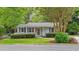 Charming single-story home with gray siding, mature trees, manicured lawn, and welcoming front porch at 423 N Main St, Wendell, NC 27591