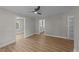 Bright and airy living room with neutral paint, modern ceiling fan, and stylish flooring at 423 N Main St, Wendell, NC 27591