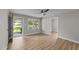 Inviting living room boasts neutral paint, a stylish ceiling fan, and durable wood-look flooring at 423 N Main St, Wendell, NC 27591