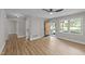 Well-lit living room featuring a contemporary ceiling fan, wood-look floors, and a welcoming open doorway at 423 N Main St, Wendell, NC 27591