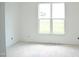 Bright bedroom features large window with a view of the outdoors and an unfinished floor at 4330 Medicus Ln, Franklinton, NC 27525