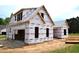 Exterior construction of a new home with protective wrap, showcasing the framing and initial stages of building at 4330 Medicus Ln, Franklinton, NC 27525