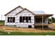 Exterior construction of a new home with protective wrap, showcasing the framing and initial stages of building at 4330 Medicus Ln, Franklinton, NC 27525