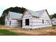 Exterior construction of a new home with protective wrap, showcasing the framing and initial stages of building at 4330 Medicus Ln, Franklinton, NC 27525