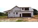 Exterior construction of a new home with protective wrap, showcasing the framing and initial stages of building at 4330 Medicus Ln, Franklinton, NC 27525