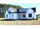Beautiful two-story home with white siding, black trim, and a well-manicured lawn, showcasing modern farmhouse style at 4330 Medicus Ln, Franklinton, NC 27525