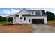 New home with a visible garage and construction materials inside at 4330 Medicus Ln, Franklinton, NC 27525