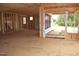 Open room framed with exposed studs, plywood flooring, and openings to the backyard, ready for customization at 4330 Medicus Ln, Franklinton, NC 27525