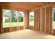 Interior framing with plywood flooring showcasing window openings, offering potential for customization and natural light at 4330 Medicus Ln, Franklinton, NC 27525