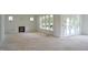 Unfinished living room with a fireplace, many windows and a door to the porch at 4330 Medicus Ln, Franklinton, NC 27525