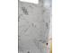 Modern shower featuring white and grey marble-style tiling and a built-in bench at 4330 Medicus Ln, Franklinton, NC 27525