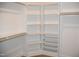 Walk-in closet with white shelves and wooden bars at 4330 Medicus Ln, Franklinton, NC 27525