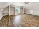 Finished attic bonus room with wood-look flooring, closets, and a window nook providing plenty of natural light at 5013 Dunwoody Trl, Raleigh, NC 27606