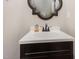 Bathroom featuring a dark vanity cabinet and decorative mirror at 5013 Dunwoody Trl, Raleigh, NC 27606