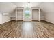 Bright bedroom featuring a window seat, open closets, and stylish wood flooring at 5013 Dunwoody Trl, Raleigh, NC 27606