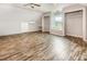 Inviting bedroom featuring a window seat, open closets, and stylish wood flooring at 5013 Dunwoody Trl, Raleigh, NC 27606