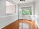 Light-filled dining room with a large bay window and wood floors at 5013 Dunwoody Trl, Raleigh, NC 27606