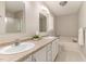 Bathroom featuring double sinks, granite countertops, and a soaking tub at 5033 Knightsbridge Way, Raleigh, NC 27604